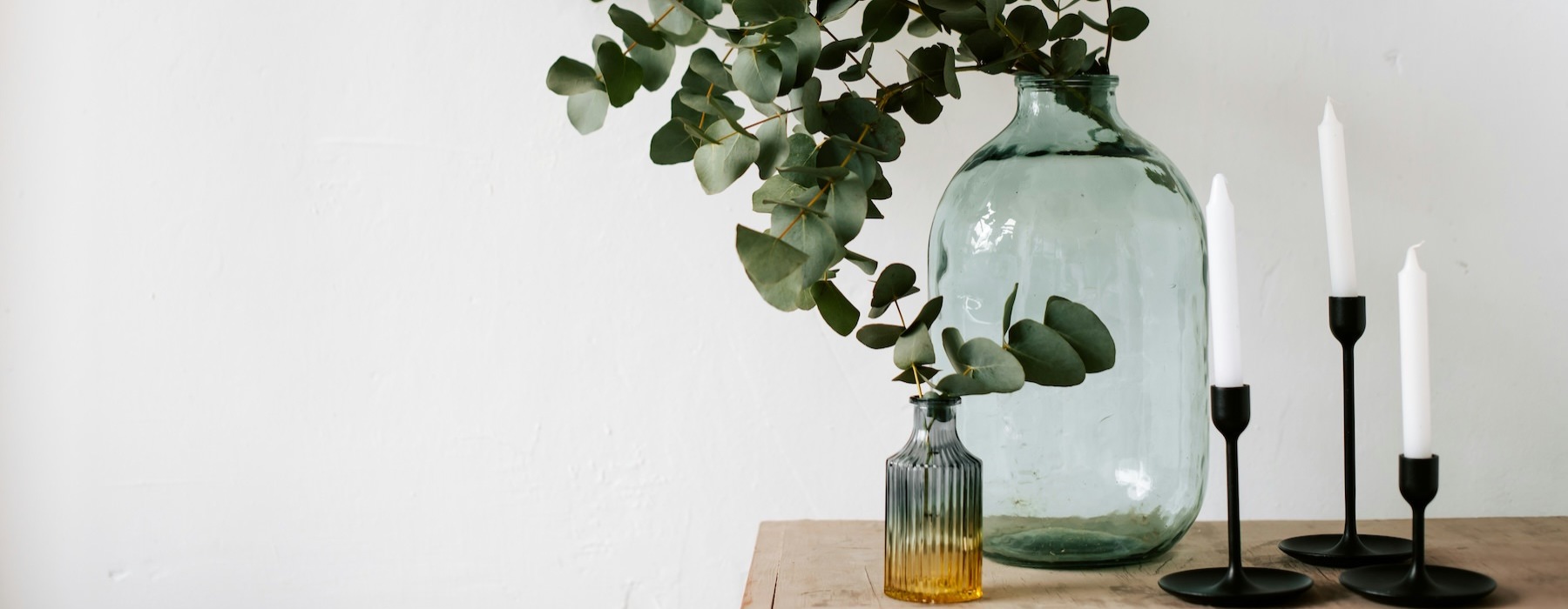 a vase with flowers and candles