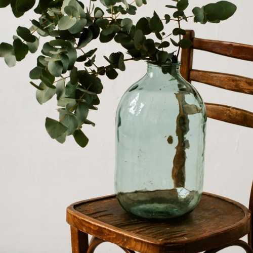 a vase with flowers on a chair